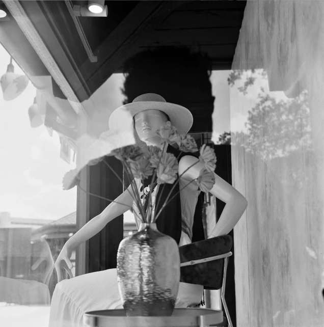 a young woman is sitting in a chair holding flowers