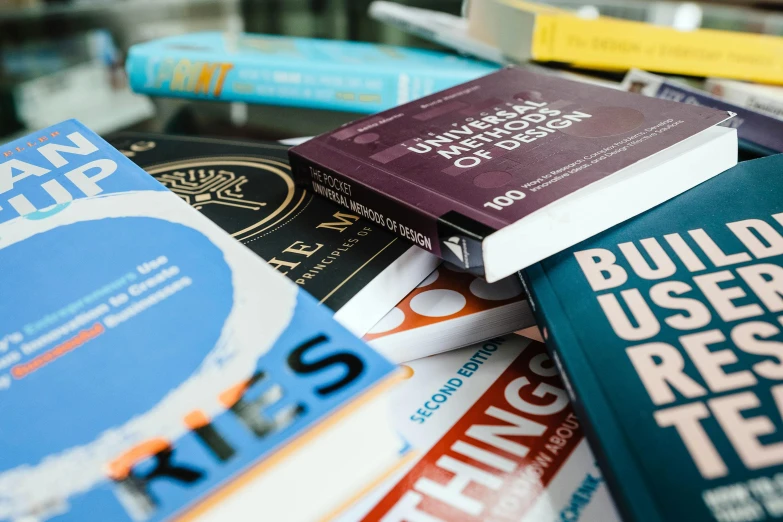 a pile of books with the cover written in bold color