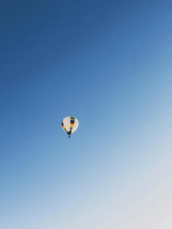 two  air balloons are flying in the sky