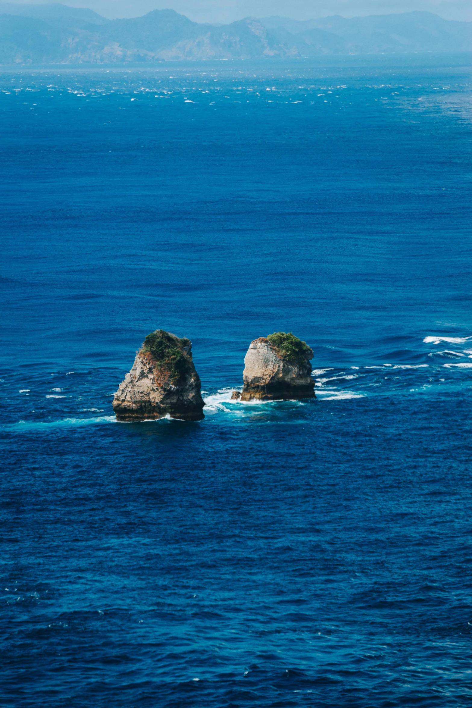 two rocks in the middle of water