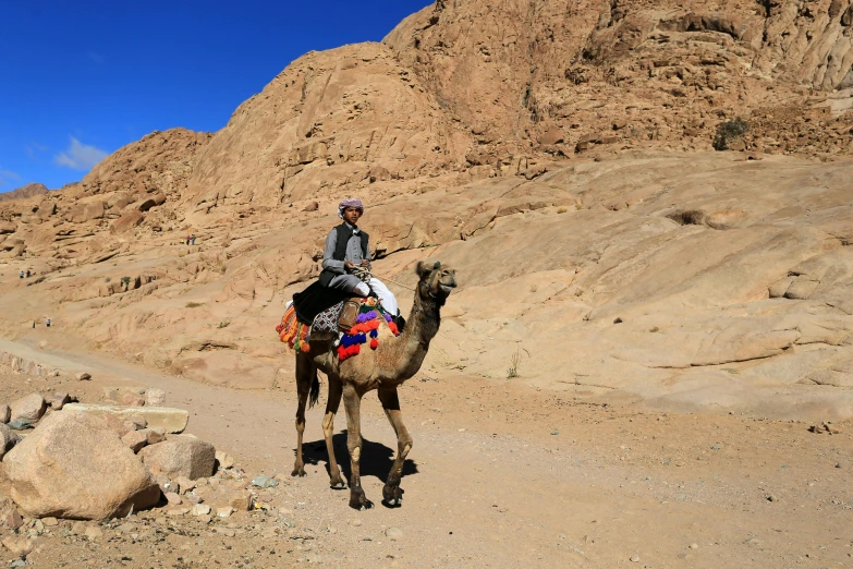 man on horseback in an arid desert area