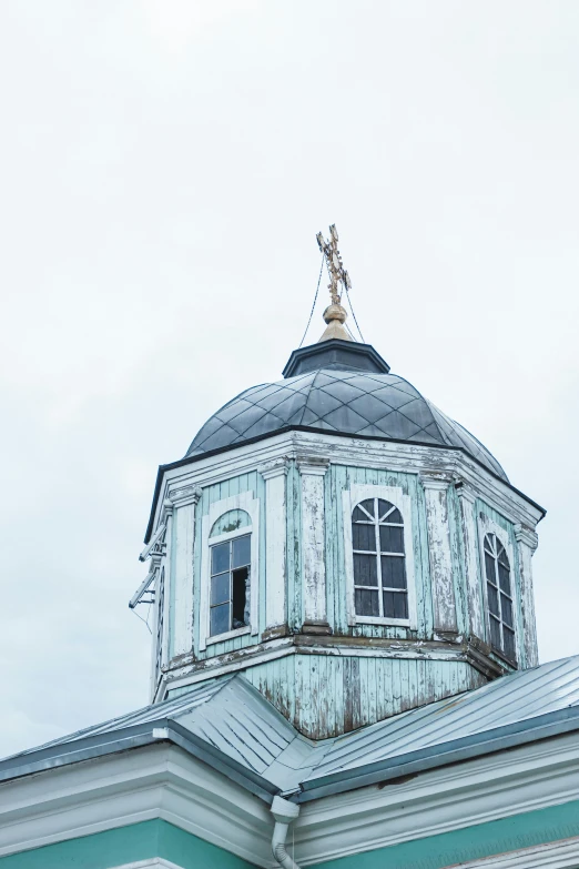 a clock tower is shown with a weathervane on top