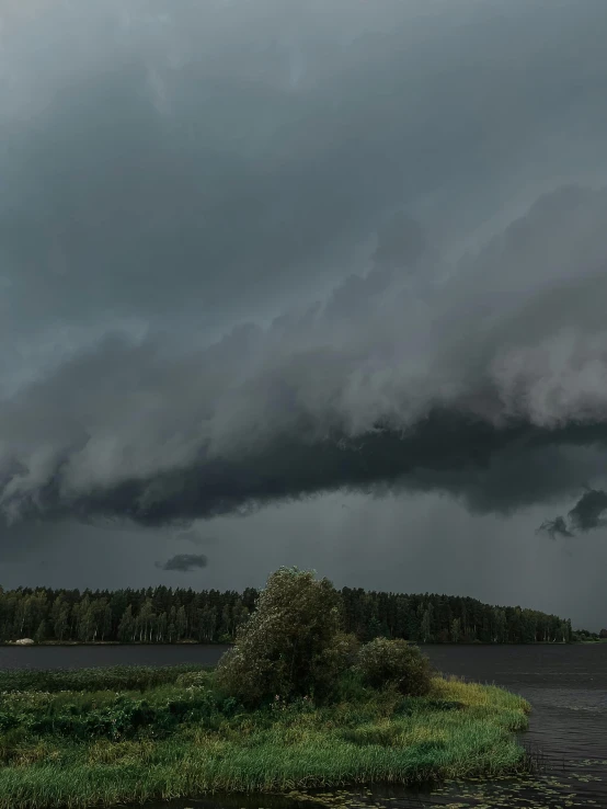 a storm approaches a small island in a river