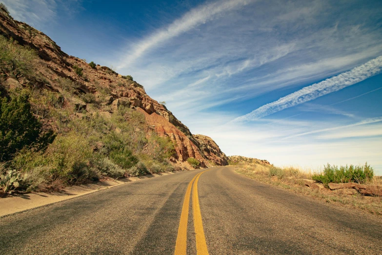 this is a road with a small cliff next to it