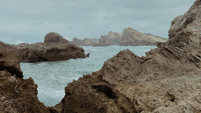 some rocks that are sitting on a beach