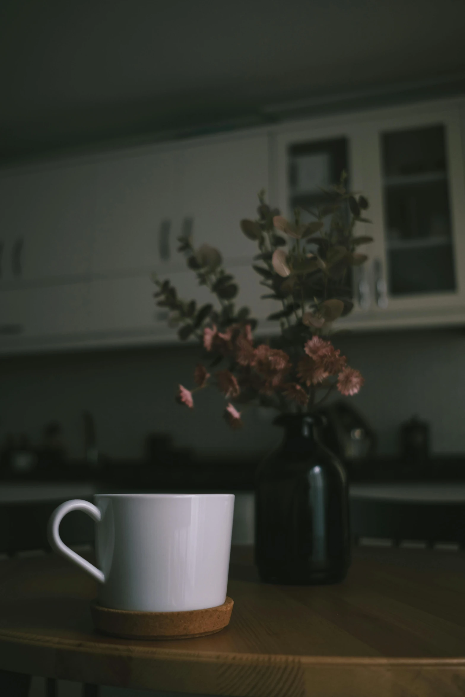 a cup with flowers sitting on a table