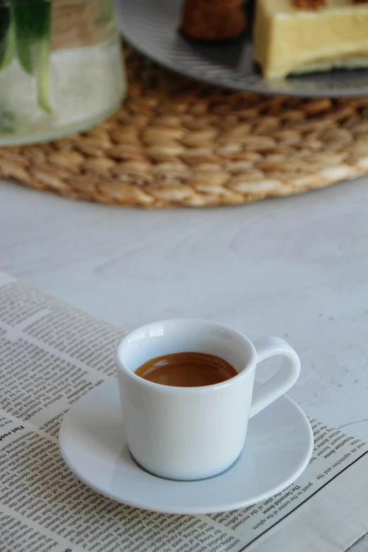 an empty coffee cup on a plate with two plates