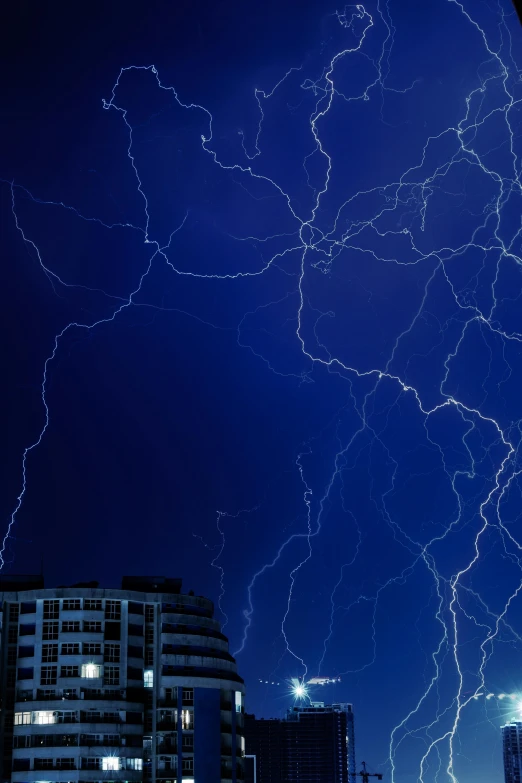 lightning is in the sky above a large city