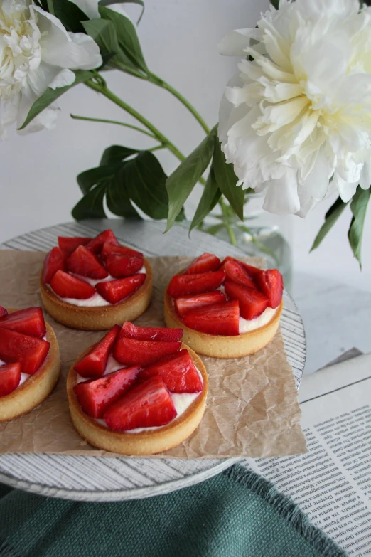 three cookies with strawberries on top of a table