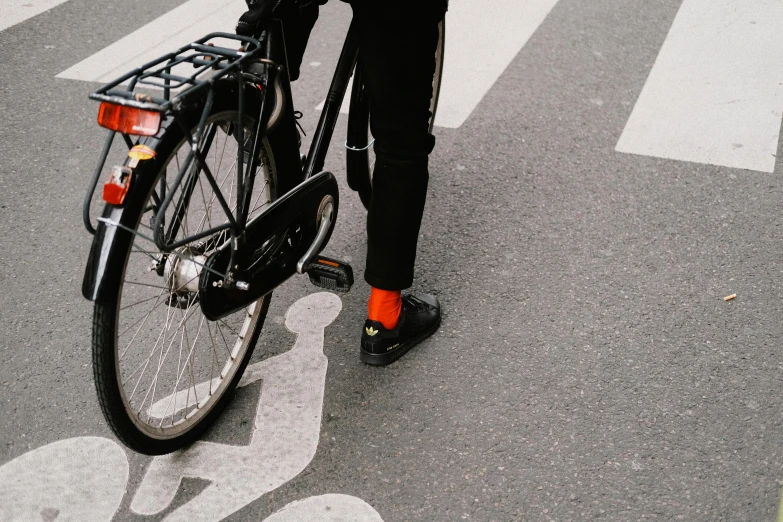 a man that is standing near a bicycle