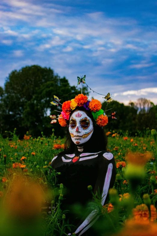 a woman in a skeleton costume with flowers on her head