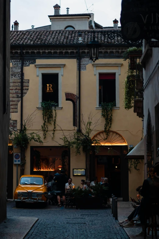 a car parked in front of a tall yellow building