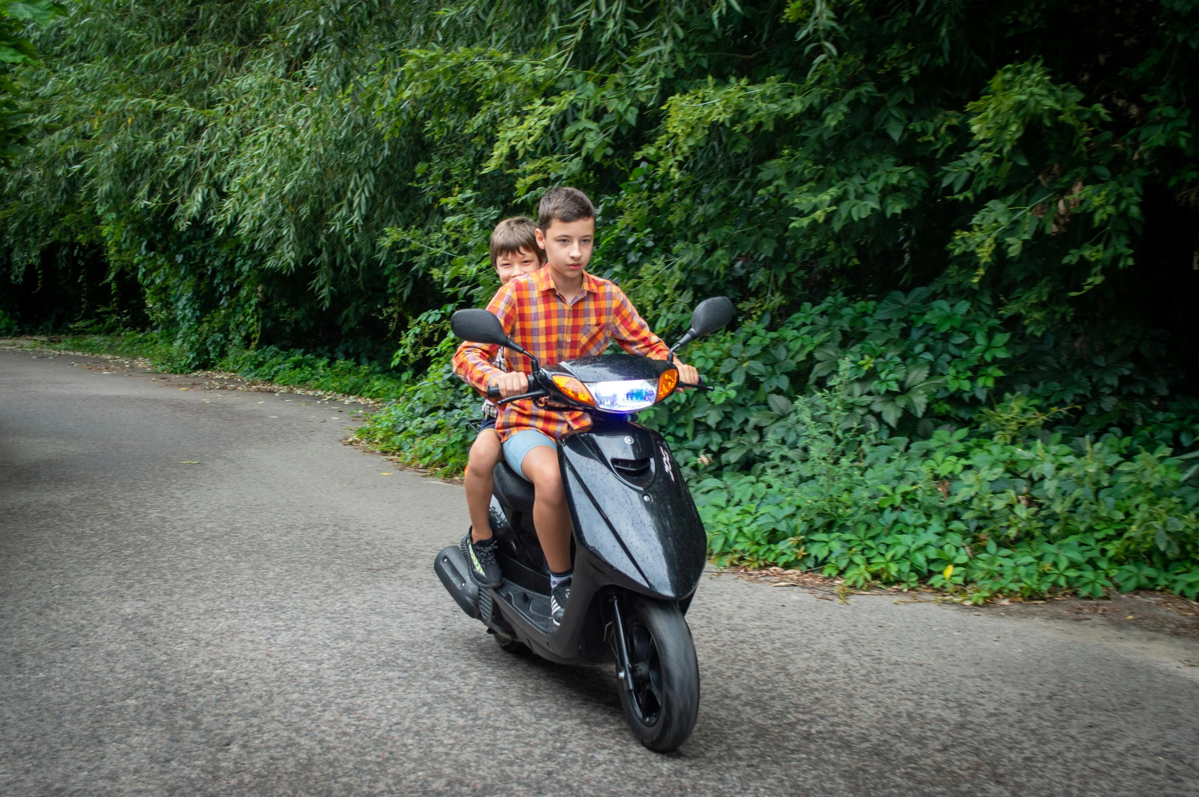 two s are riding on the motorcycle