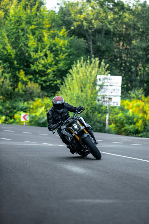 a man is riding a motor bike on a road