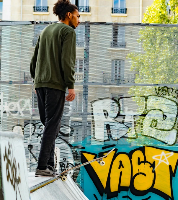 a person on a skateboard rides along a graffiti covered wall