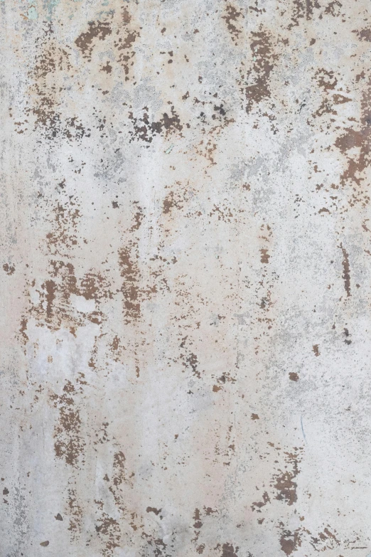 a dirty concrete wall with some color stains