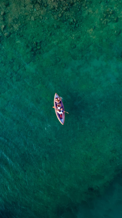 a small boat is sitting out on some water