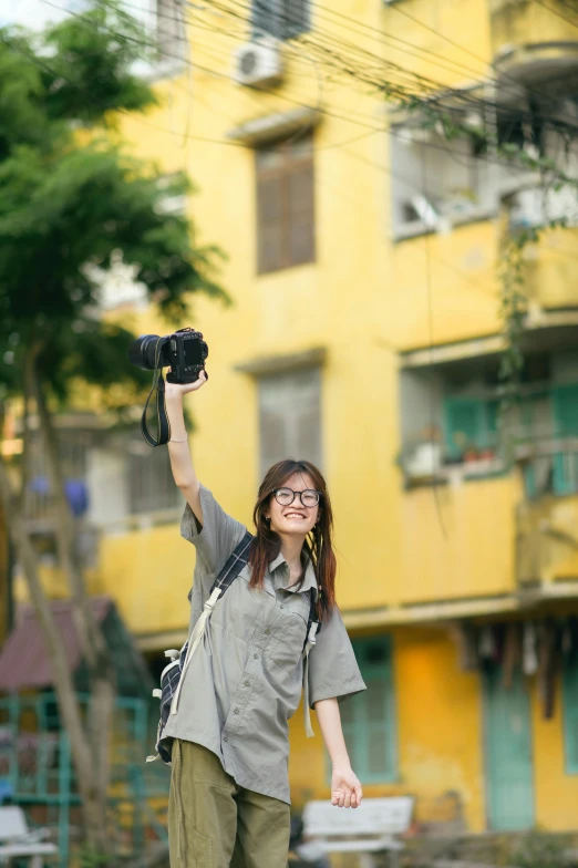 woman with glasses taking a po holding her cellphone