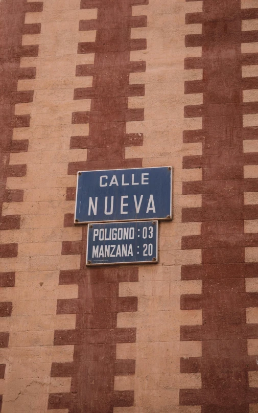a street sign and name plate on an ornately patterned wall