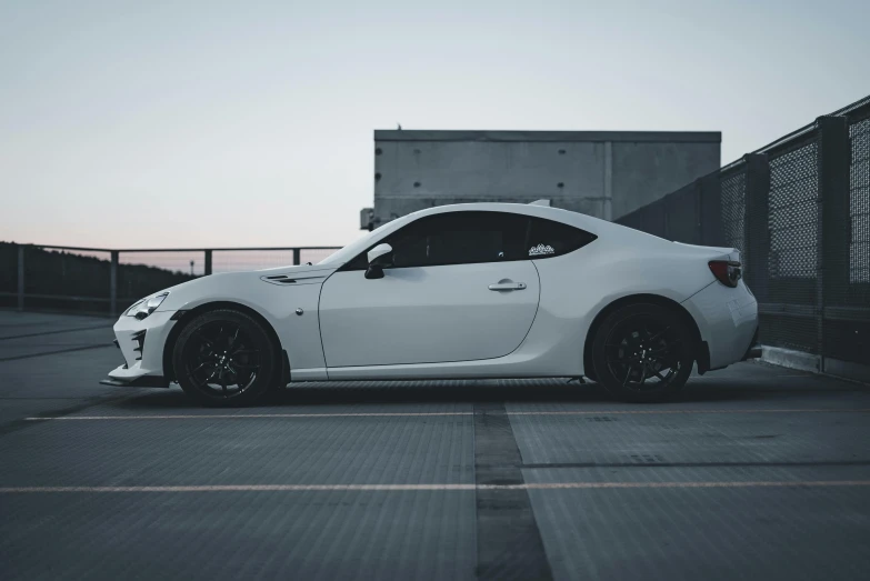 a white car parked on top of an empty lot