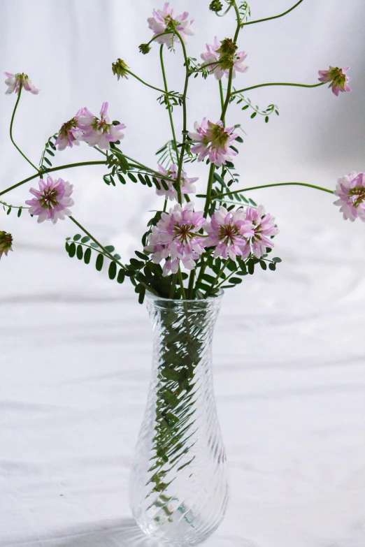 a glass vase with pink flowers in it