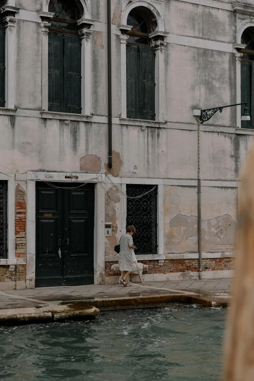 a man walking down the street next to a woman