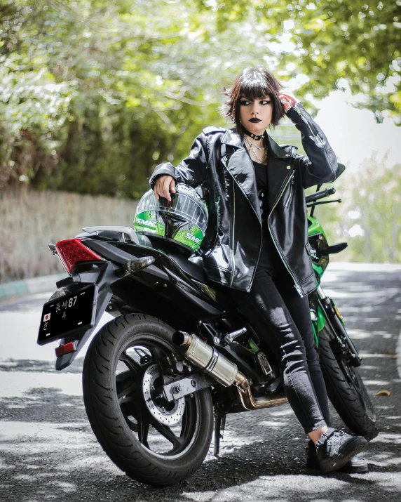 a man sitting on the back of a motorcycle in the middle of a street