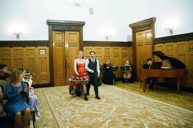 two people dancing in the middle of an auditorium