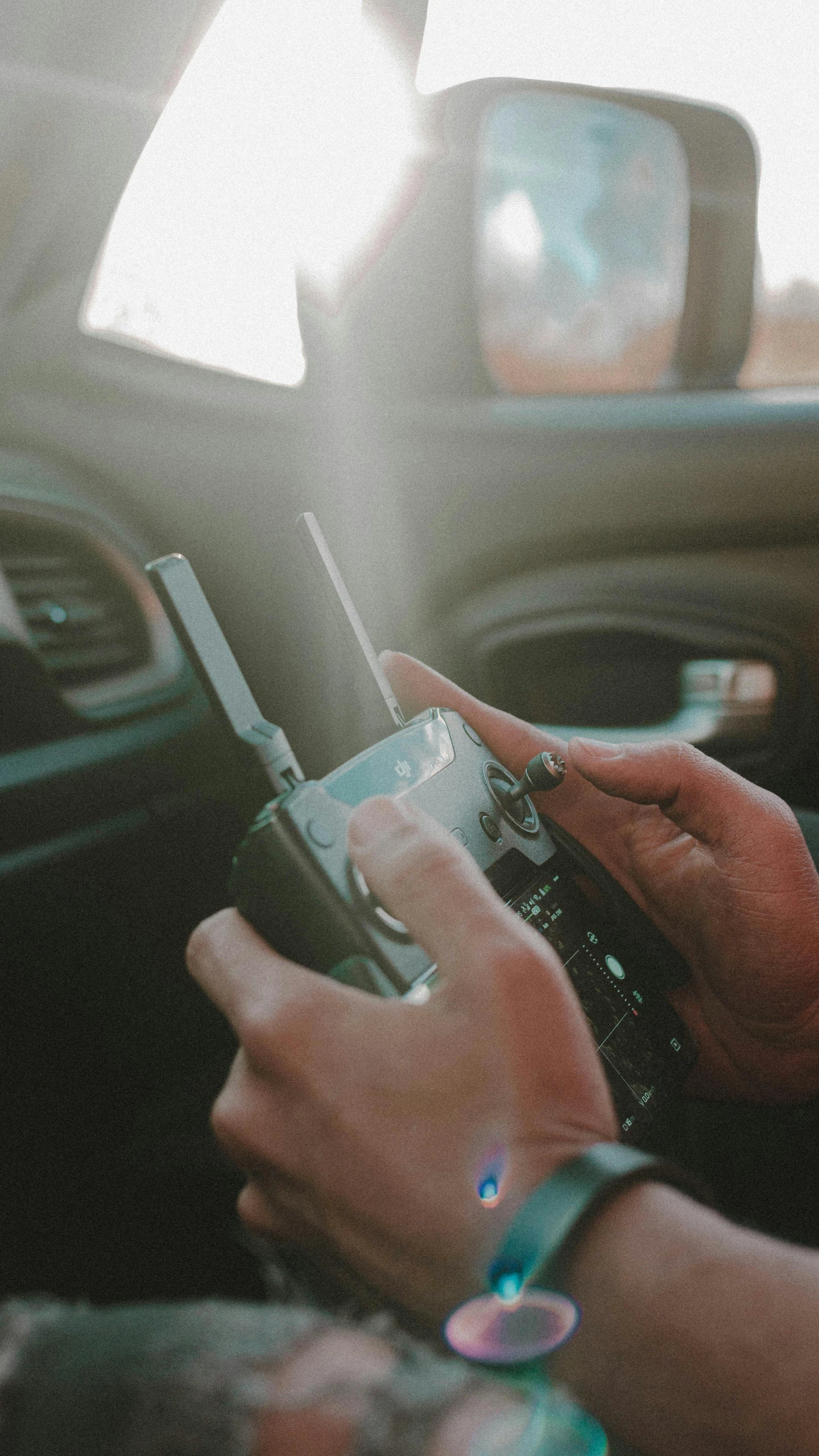 woman on cell phone sitting inside car using device