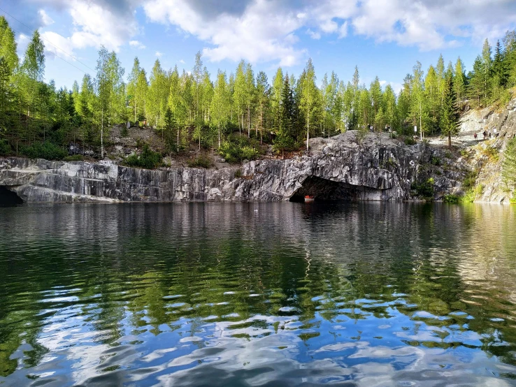 a lake with a large rock formation in it