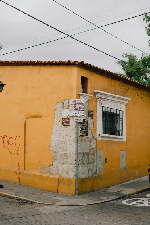 graffiti is on the side of a yellow building