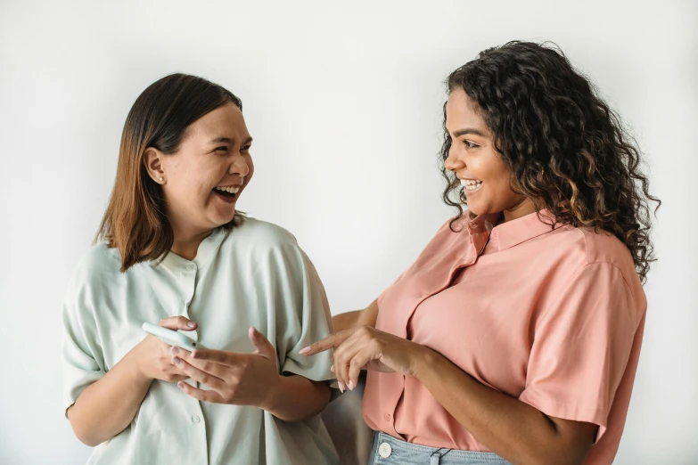 two women with different colored tops standing near each other