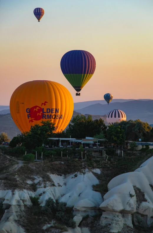  air balloons float over rocks near the desert