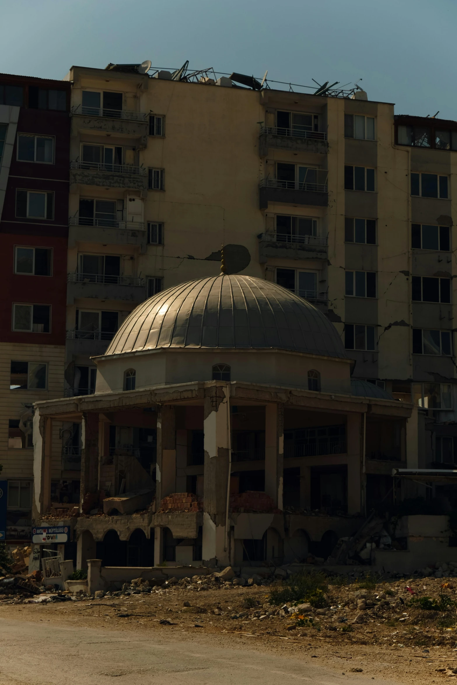 a very old, run down building is next to a building with windows