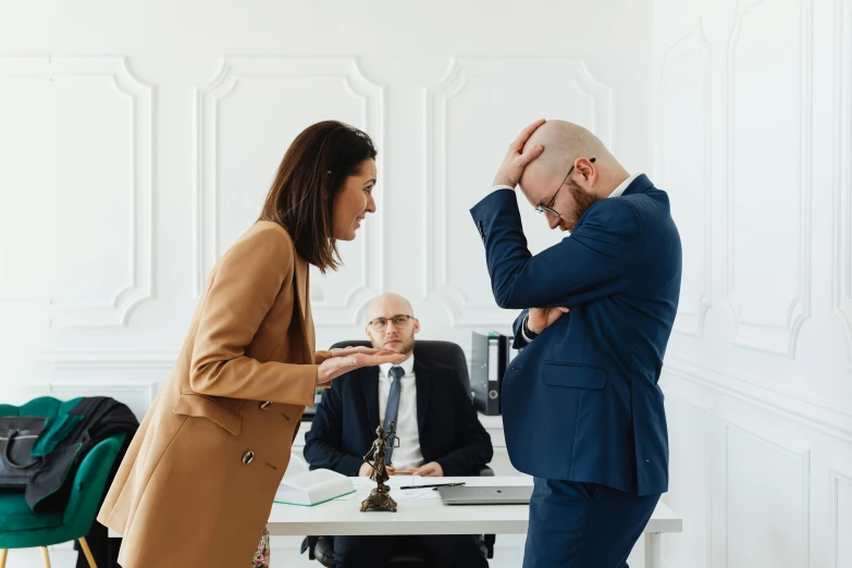 two people stand at a table facing one another, and they both hold their heads together