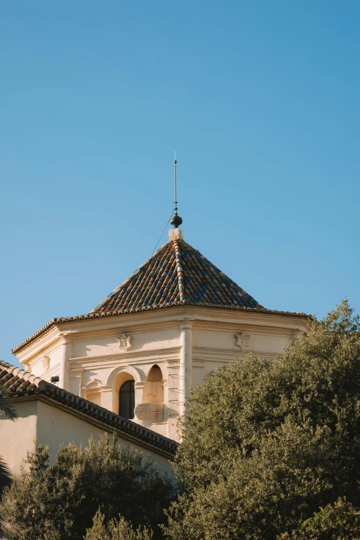 a very old building with some trees in front