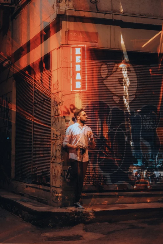 the young man is leaning against the side of the building