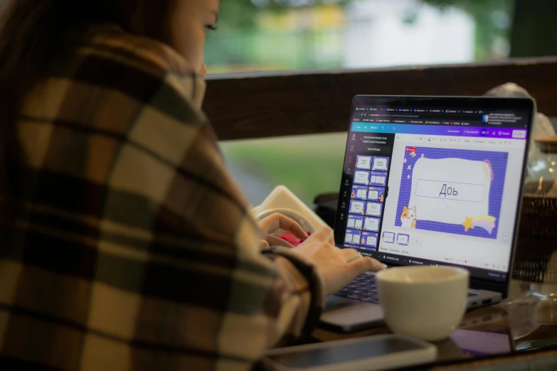 a woman uses a laptop computer on a table