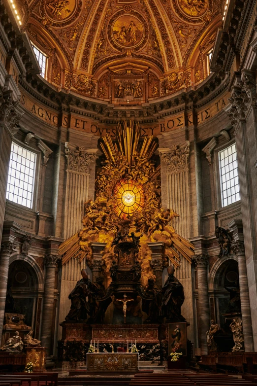 the altar and the intricate golded decoration is in the center of this cathedral