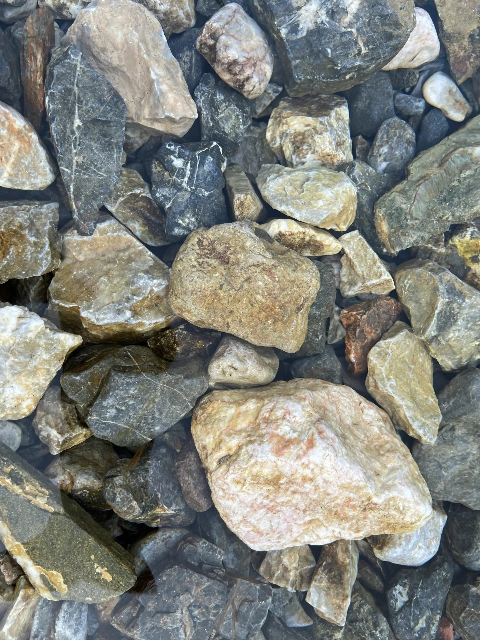 rocks are mixed together on a rocky surface