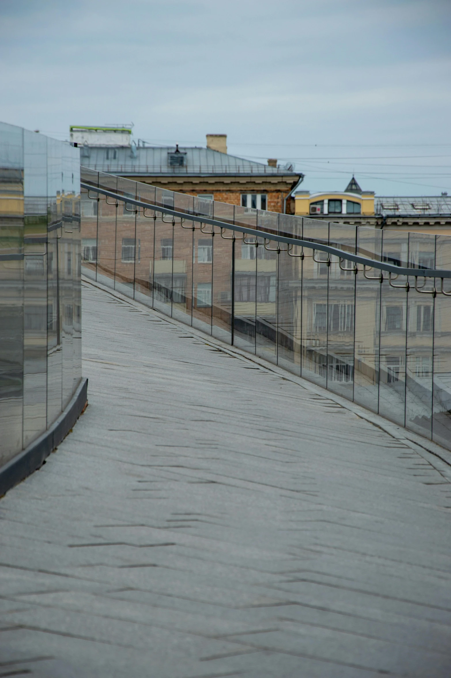 a walkway with multiple barriers and street lights along side