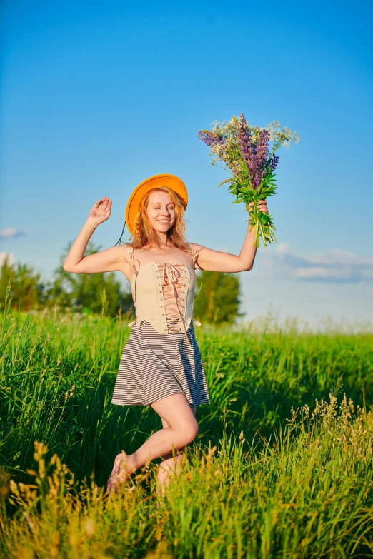 a woman in a plaid dress holding a bouquet of flowers