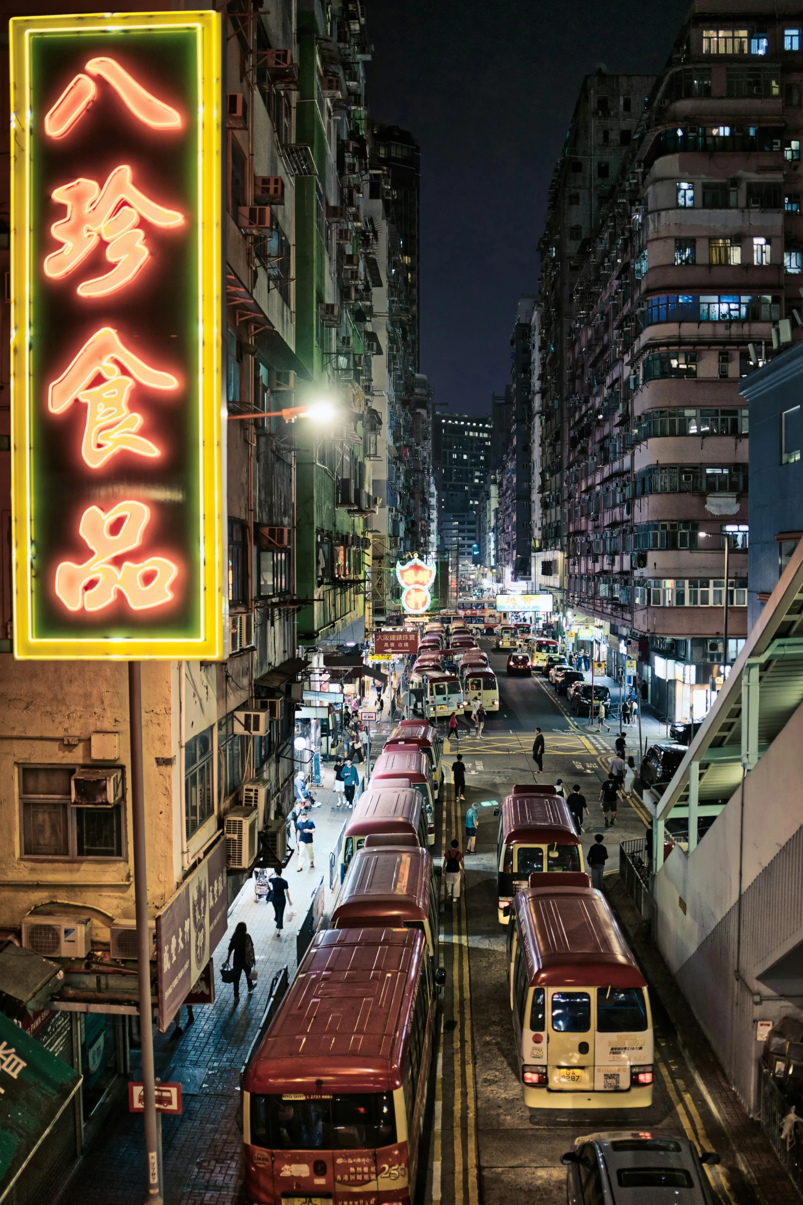 buses in the street in an urban area at night