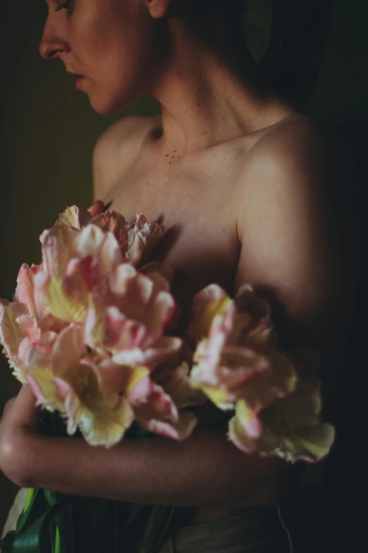 a young woman holding flowers of various colors