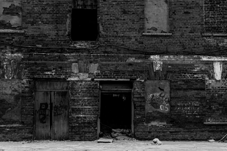 an old brick building with broken windows and doors