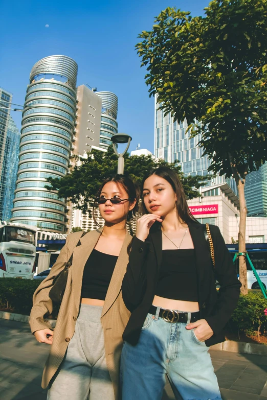 two women standing near each other on the sidewalk