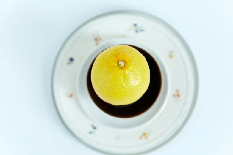 a lemon is in a saucer on a table