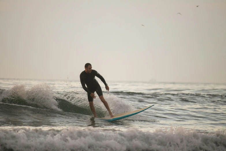 there is a man surfing in the water