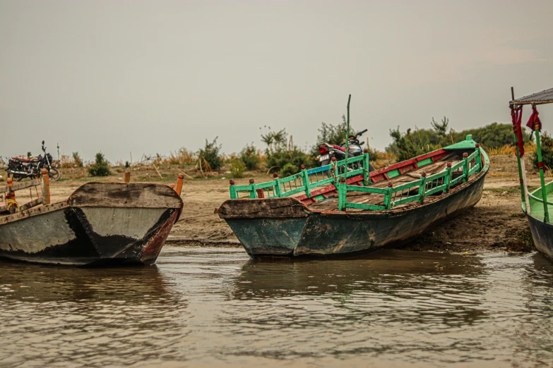 a group of boats floating on top of a body of water