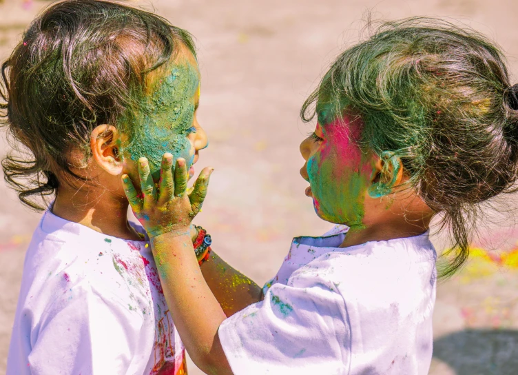 two little girls with their face smeared green